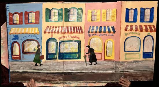 Rue du village avec passantes et devantures de commerces