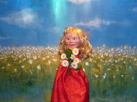 Boucle d'Or dans la prairie tient un bouquet de fleurs