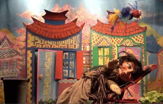 Perle d'Or sur sa chaise longue devant deux maisons colorées