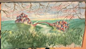 Deux villages dans des collines vertes, reliés par un pont au-dessus d'une rivière