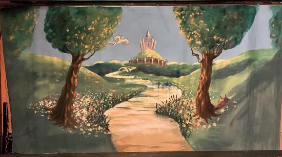 Prairie en fleur, arbres, rivière, château à l'horizon